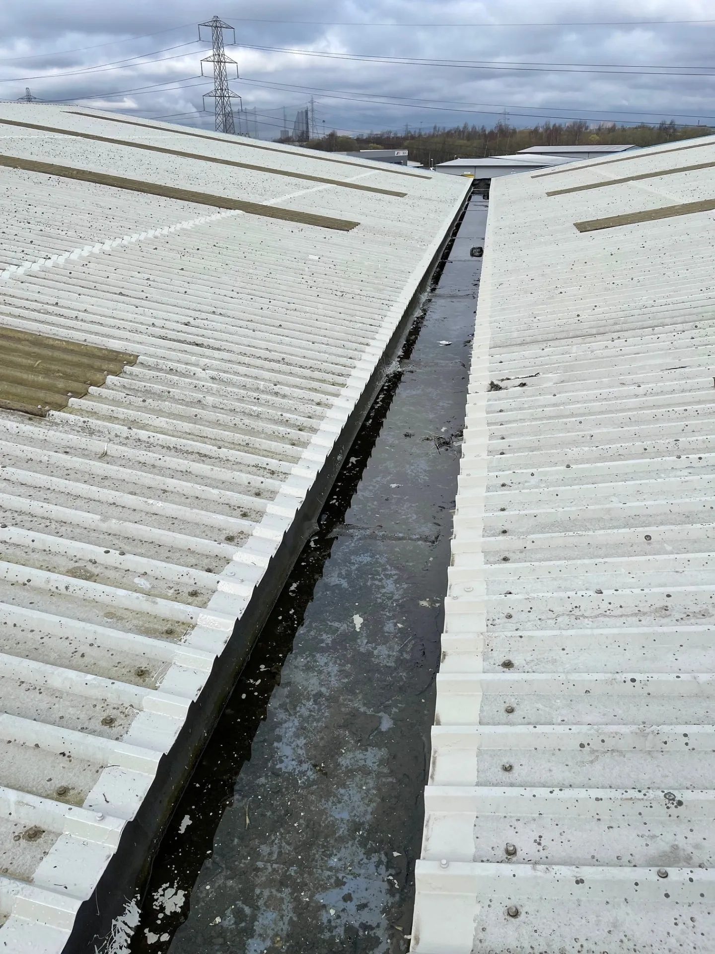 Cut edge corrosion treatment complete on industrial roof sheet laps