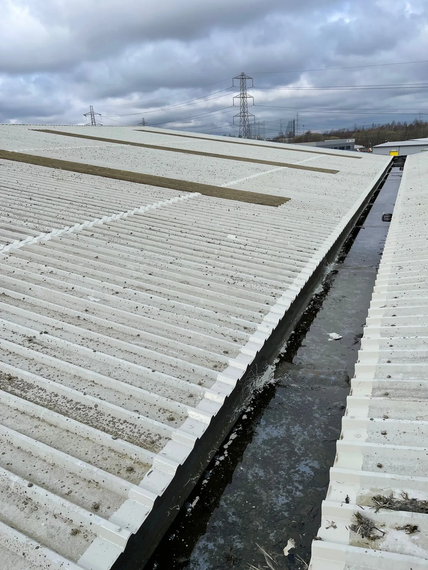 Completed cut edge corrosion treatment protecting sheet ends on metal roof