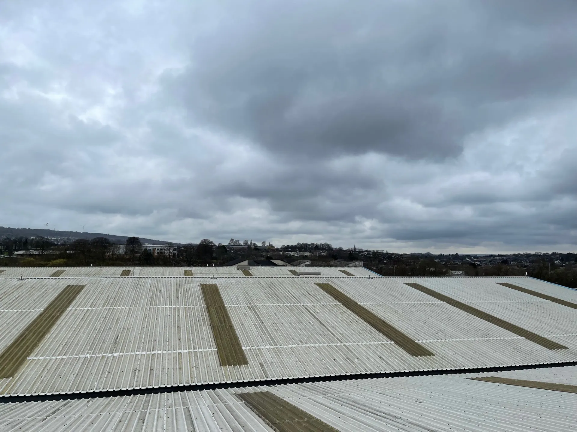 Industrial roof cut edge corrosion treatment complete after primer and two Sika coats