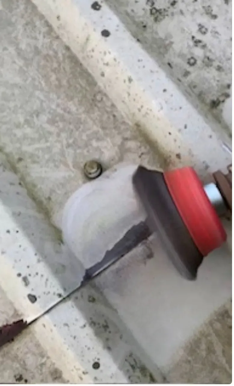 Grinding cut edge corrosion back to sound metal before primer and Sika treatment