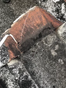 Hole caused by cut edge corrosion on metal industrial roof
