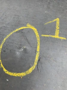 Membrane damage marked with chalk during industrial roof survey