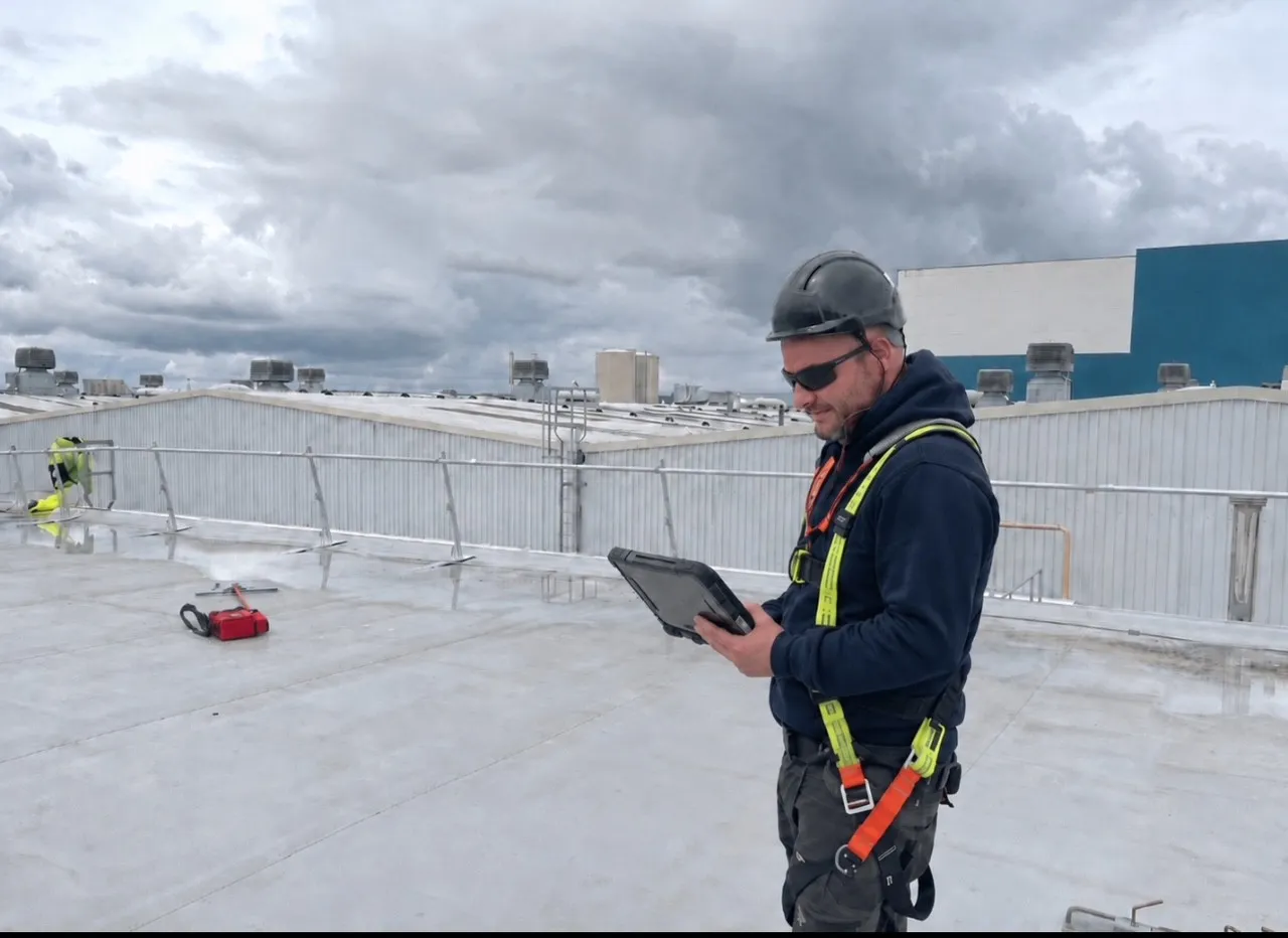 Modern Roofing Technical Roof Surveyor inspecting an industrial roof