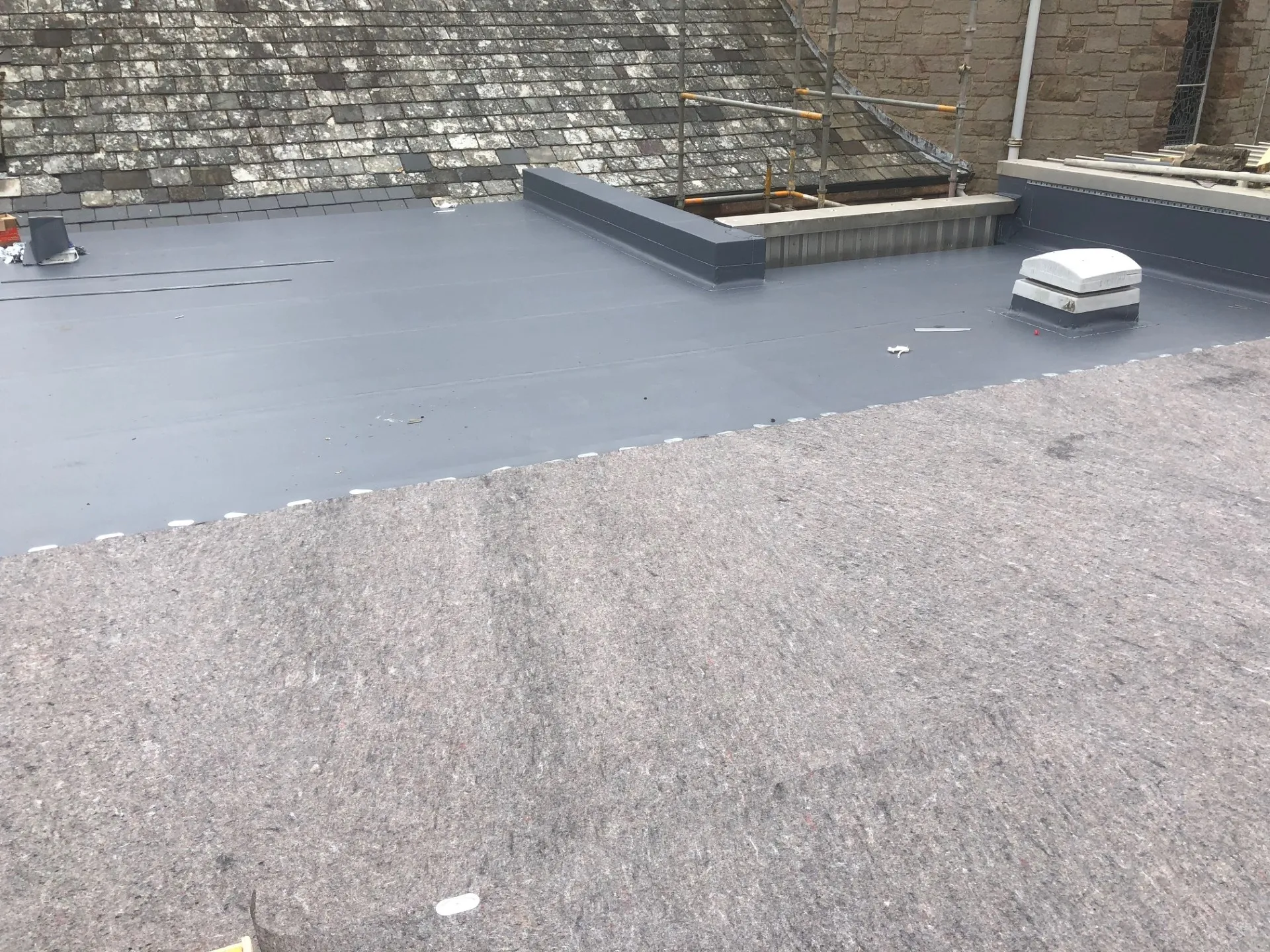 Protective fleece layer and single ply membrane being installed at Fairmile Church Edinburgh